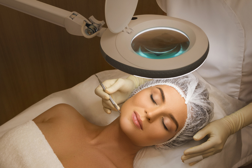 Woman during a mechanical face cleansing procedure
